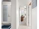 Bright entry hall with front door and view into an adjacent room at 5207 Pine Shadow Ln, North Port, FL 34287