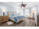 Main bedroom with light walls, ceiling fan, and wood-look floors at 5207 Pine Shadow Ln, North Port, FL 34287