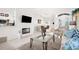 Open concept living area with fireplace, dining space, and a large TV at 5207 Pine Shadow Ln, North Port, FL 34287
