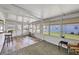 Bright sunroom with vinyl flooring, a ceiling fan, and access to the outdoors at 718 50Th Avenue W Dr, Bradenton, FL 34207