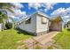 Single-wide manufactured home with landscaped yard at 718 50Th Avenue W Dr, Bradenton, FL 34207
