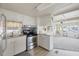 Bright kitchen features stainless steel appliances and white cabinets at 718 50Th Avenue W Dr, Bradenton, FL 34207