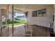 Covered patio with table and chairs, overlooks backyard at 718 50Th Avenue W Dr, Bradenton, FL 34207