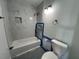 Bathroom featuring marble tile, a bathtub, a shower, and a toilet at 21288 Edgewater Dr, Port Charlotte, FL 33952