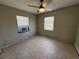 Bedroom with tile flooring, a ceiling fan and two windows providing natural light at 21288 Edgewater Dr, Port Charlotte, FL 33952