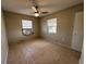 Bedroom with tile flooring, a ceiling fan and two windows providing natural light at 21288 Edgewater Dr, Port Charlotte, FL 33952