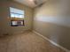 Bedroom featuring tile flooring and a window providing natural light at 21288 Edgewater Dr, Port Charlotte, FL 33952