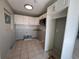 Bright kitchen featuring tile flooring, white cabinetry, a microwave and white subway tile backsplash at 21288 Edgewater Dr, Port Charlotte, FL 33952