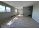 Bright living room featuring tile flooring, windows and modern light fixture at 21288 Edgewater Dr, Port Charlotte, FL 33952