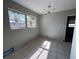 Bright living room features tile flooring, a modern light fixture and a palm tree view at 21288 Edgewater Dr, Port Charlotte, FL 33952