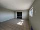Spacious living room features tile flooring, a window and a large open doorway at 21288 Edgewater Dr, Port Charlotte, FL 33952