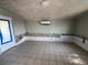 Living room featuring tile flooring, exposed cinder block and whitewashed wood-paneled ceiling at 21288 Edgewater Dr, Port Charlotte, FL 33952