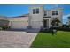 Inviting two-story home featuring a paved driveway, a two-car garage, and manicured landscaping at 4322 Silo Port Ct, Lakewood Ranch, FL 34211