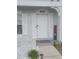 Close-up view of the front door with a welcome sign and decorative lighting, enhancing curb appeal at 4629 Sabal Key Dr # 4629, Bradenton, FL 34203