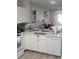 Well-lit kitchen with sleek appliances, white cabinetry, and an open layout adjacent to the living area at 4629 Sabal Key Dr # 4629, Bradenton, FL 34203