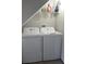 Efficient laundry area with white washer and dryer units conveniently located under a shelf at 4629 Sabal Key Dr # 4629, Bradenton, FL 34203