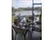Relaxing screened patio featuring outdoor dining set and serene lake views at 4629 Sabal Key Dr # 4629, Bradenton, FL 34203