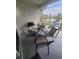 Cozy outdoor patio with lake view, features dining table, grill, and comfortable seating for relaxing and entertaining at 4629 Sabal Key Dr # 4629, Bradenton, FL 34203