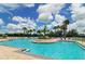 Large community pool surrounded by palm trees and lounge chairs, perfect for summer relaxation and recreation at 4629 Sabal Key Dr # 4629, Bradenton, FL 34203