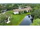 Aerial view of a condo community featuring lush landscaping and a tranquil pond at 752 White Pine Tree Rd # 206, Venice, FL 34285