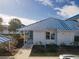 Charming single-story home with a blue metal roof and well-maintained landscaping at 835 Audubon Dr # 835, Bradenton, FL 34209