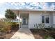 Inviting front porch with white columns and freshly landscaped yard, perfect for relaxing at 835 Audubon Dr # 835, Bradenton, FL 34209