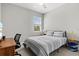 Bedroom with striped bedding, desk, chair, and window at 904 Whimbrel Run, Bradenton, FL 34212