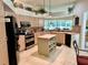 Spacious kitchen featuring an island, stainless steel appliances, and ample cabinetry at 5658 Downham Meadows, Sarasota, FL 34235