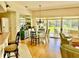Bright dining area with hardwood floors, glass table, and access to backyard patio at 5658 Downham Meadows, Sarasota, FL 34235