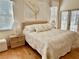 Main bedroom with king-size bed, hardwood floors, and access to a private balcony at 5658 Downham Meadows, Sarasota, FL 34235