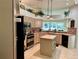 Bright kitchen with an island and stainless steel appliances at 5658 Downham Meadows, Sarasota, FL 34235