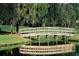 Picturesque bridge over a pond with lush greenery at 5658 Downham Meadows, Sarasota, FL 34235