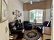 Comfortable office with leather armchairs, hardwood floors, and large windows at 5658 Downham Meadows, Sarasota, FL 34235