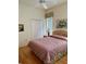 Cozy bedroom with hardwood floors, a double bed, and ample closet space at 5658 Downham Meadows, Sarasota, FL 34235