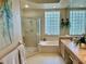 Luxurious bathroom with double vanity, soaking tub, and walk-in shower at 5658 Downham Meadows, Sarasota, FL 34235