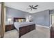 Main bedroom with king bed, ceiling fan, and ensuite access at 7552 Aguila Dr, Sarasota, FL 34240