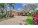 Exterior view of charming one-story home with brick paver driveway at 14717 Leopard Creek Pl, Lakewood Ranch, FL 34202
