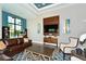 Comfortable lounge area with large screen TV and seating at 14717 Leopard Creek Pl, Lakewood Ranch, FL 34202