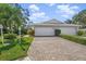 Exterior view of a house with a double garage and a brick paved driveway at 3778 Bonaventure Ct, Sarasota, FL 34243