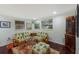 Charming sitting room with unique pineapple print furniture and built-in shelving at 1922 Field Rd, Sarasota, FL 34231