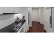 Modern kitchen with white cabinets, black countertops, and stainless steel appliances at 1922 Field Rd, Sarasota, FL 34231