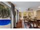 Bright dining room with hardwood floors, fireplace, and pool view at 1922 Field Rd, Sarasota, FL 34231
