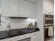 Modern kitchen with white cabinets, black countertops, and stainless steel appliances at 1922 Field Rd, Sarasota, FL 34231