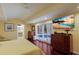 Main bedroom with hardwood floors, large TV, and pool access at 1922 Field Rd, Sarasota, FL 34231