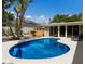 Relaxing kidney shaped pool with patio seating at 1922 Field Rd, Sarasota, FL 34231