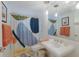 Bathroom with modern vanity, abstract shower curtain at 1922 Field Rd, Sarasota, FL 34231