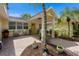 Private courtyard entry with brick pavers and lush landscaping at 1922 Field Rd, Sarasota, FL 34231