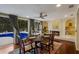 Elegant dining room with a view of the pool and built-in shelving at 1922 Field Rd, Sarasota, FL 34231