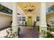 Inviting entryway with a bright yellow door and a covered porch at 1922 Field Rd, Sarasota, FL 34231