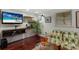 Stylish bar area with a flat-screen TV and built-in shelving at 1922 Field Rd, Sarasota, FL 34231